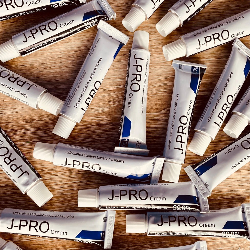 J-Pro numbing cream tube for tattooing, microblading, and permanent makeup, featuring a sleek design.