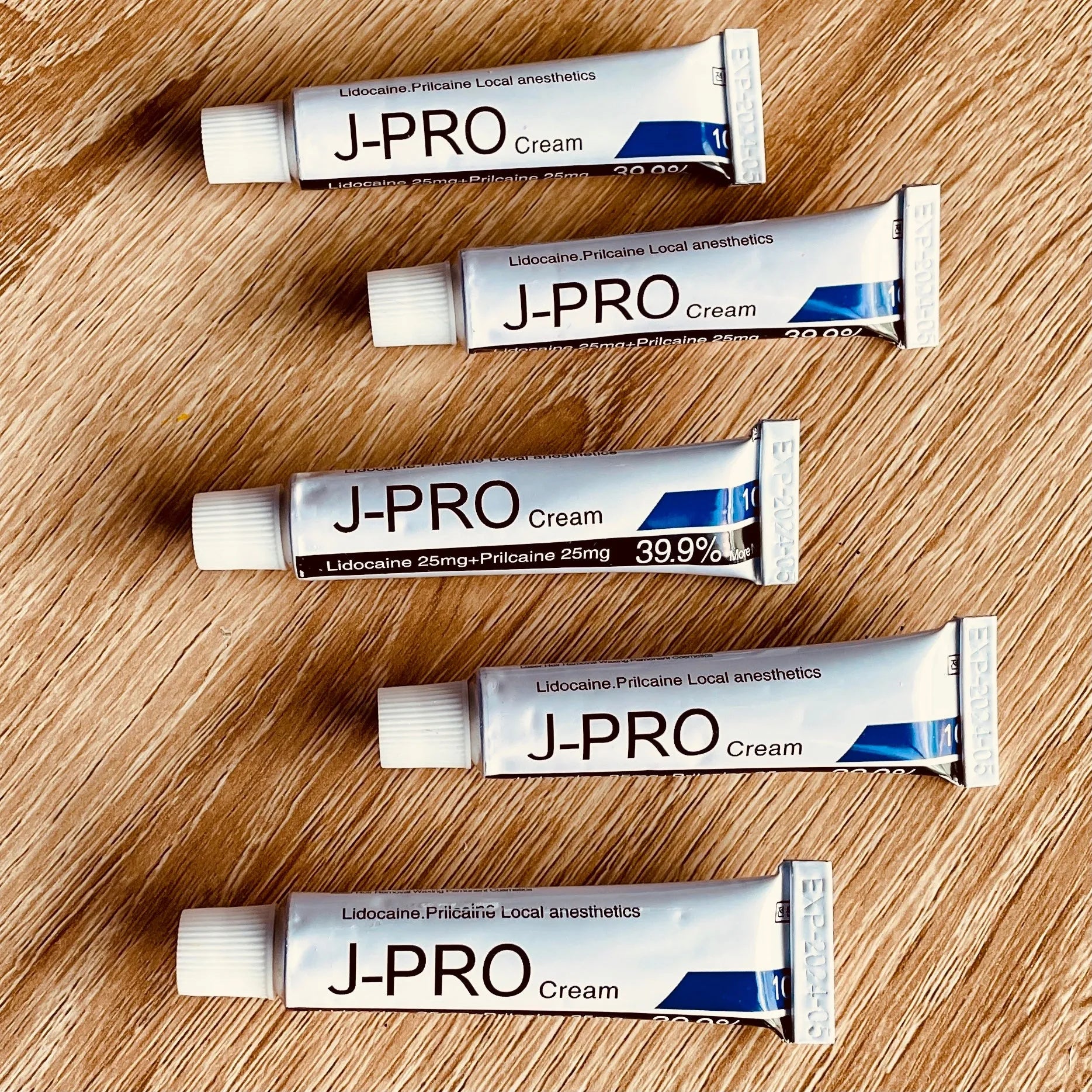 J-Pro numbing cream tube for tattooing, microblading, and permanent makeup, featuring a sleek design and easy application.