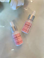 Pink lash and brow growth oil bottles with dropper tops from BeautyNomix, featuring vitamin E and castor oil.